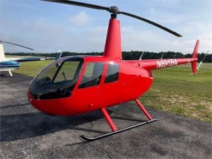 A training helicopter sitting on the runway